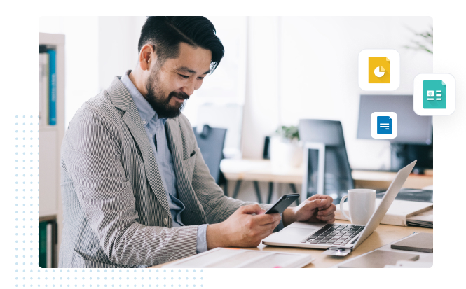 professional working at laptop and smiling at mobile phone